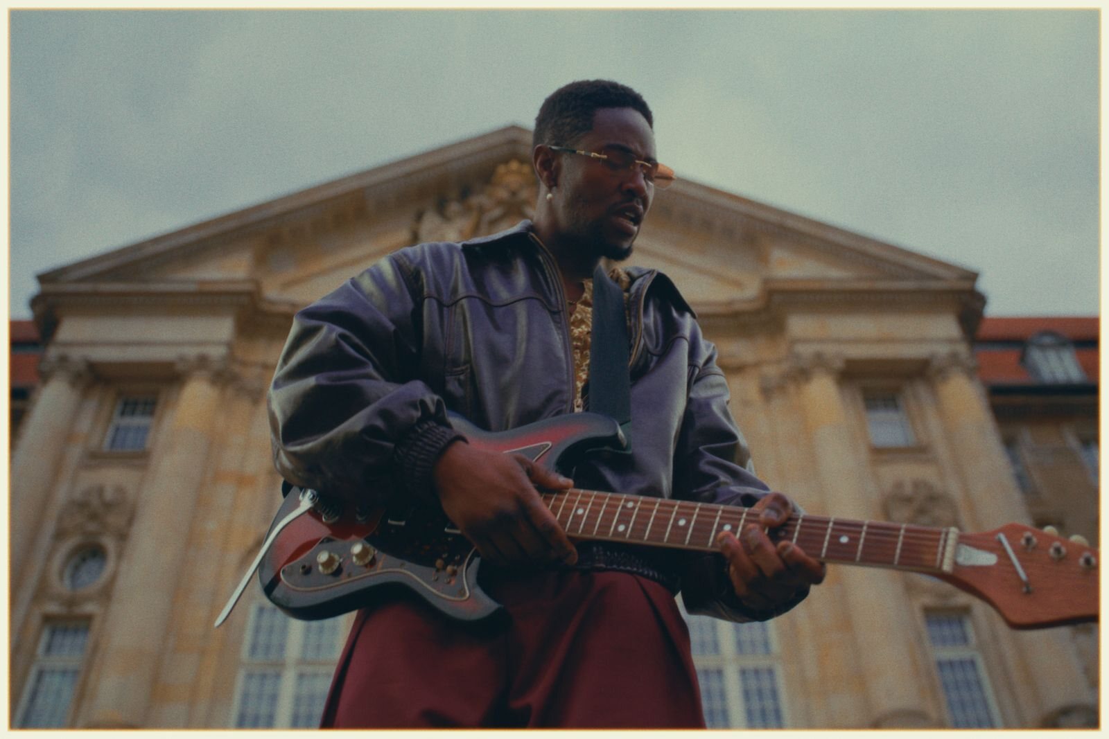 Mani Simon outdoors among stone columns